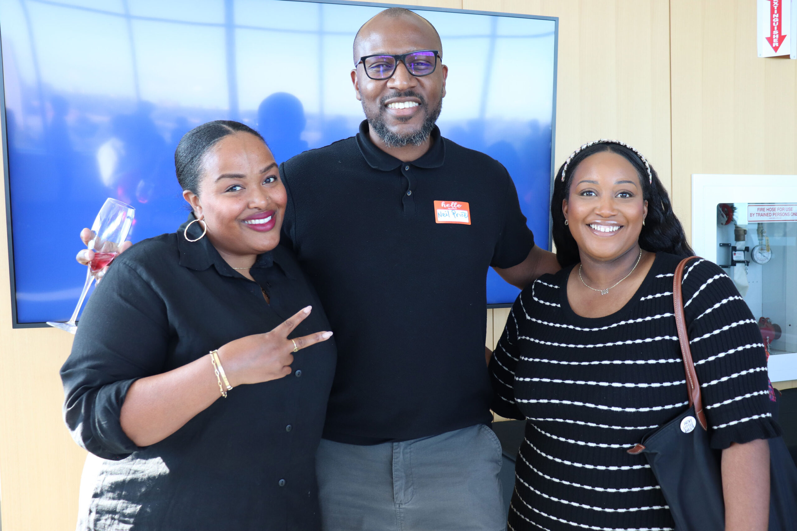 Founder and Executive Director Camesha Cox stands beside two members of the TRP Board of Directors. They all smile at the camera.