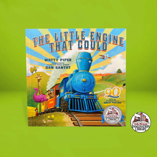 A children’s book stands in front of a green backdrop. The book title is “The Little Engine That Could.”