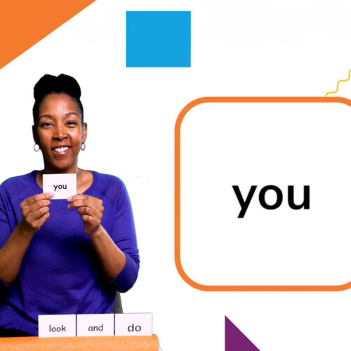 A screenshot of the online learning platform. An educator holds up a cue card with the word “you” on it.